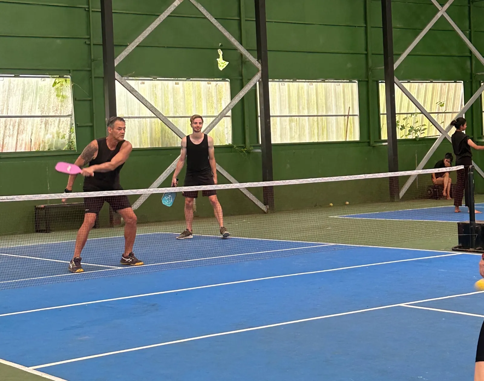 Players on the indoor pickleball court at White Sand Beach Resort, Koh Mak