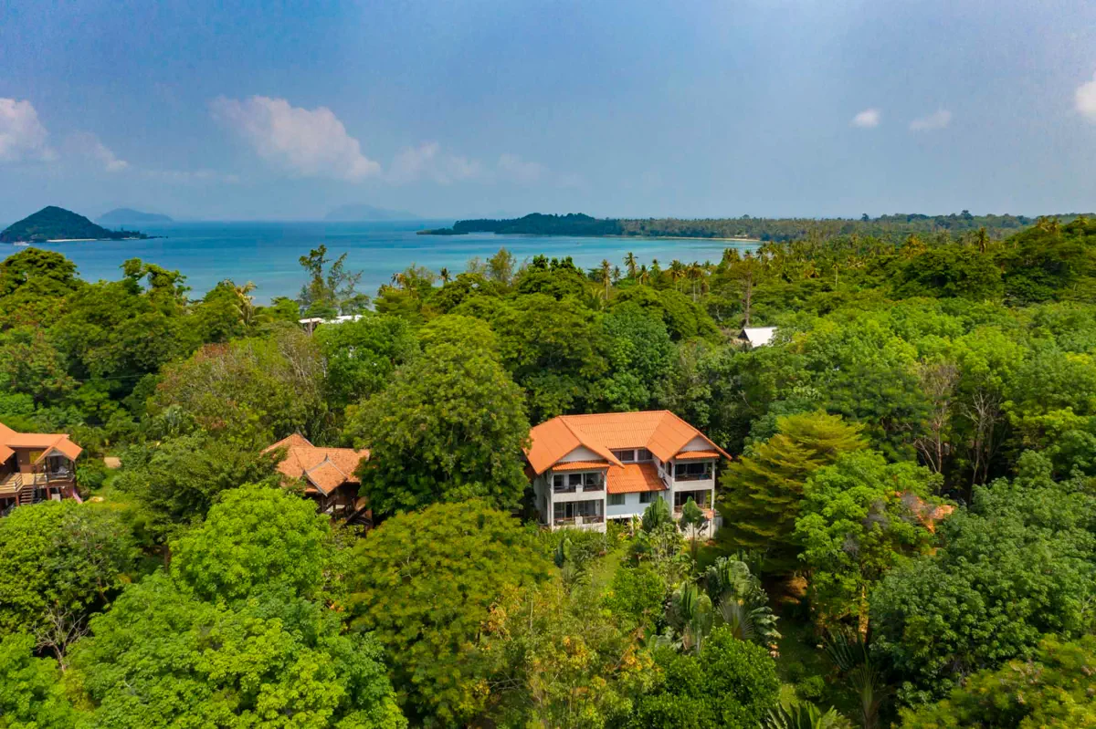 Aerial view of Garden Suites at Koh Mak Village nestled in tropical greenery with ocean backdrop