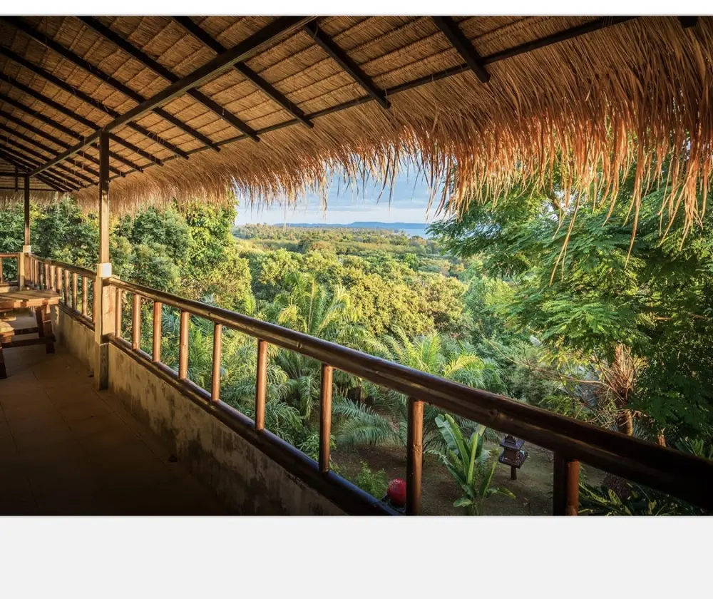 Thatched-roof terrace overlooking tropical forest at Koh Mak Village Collection