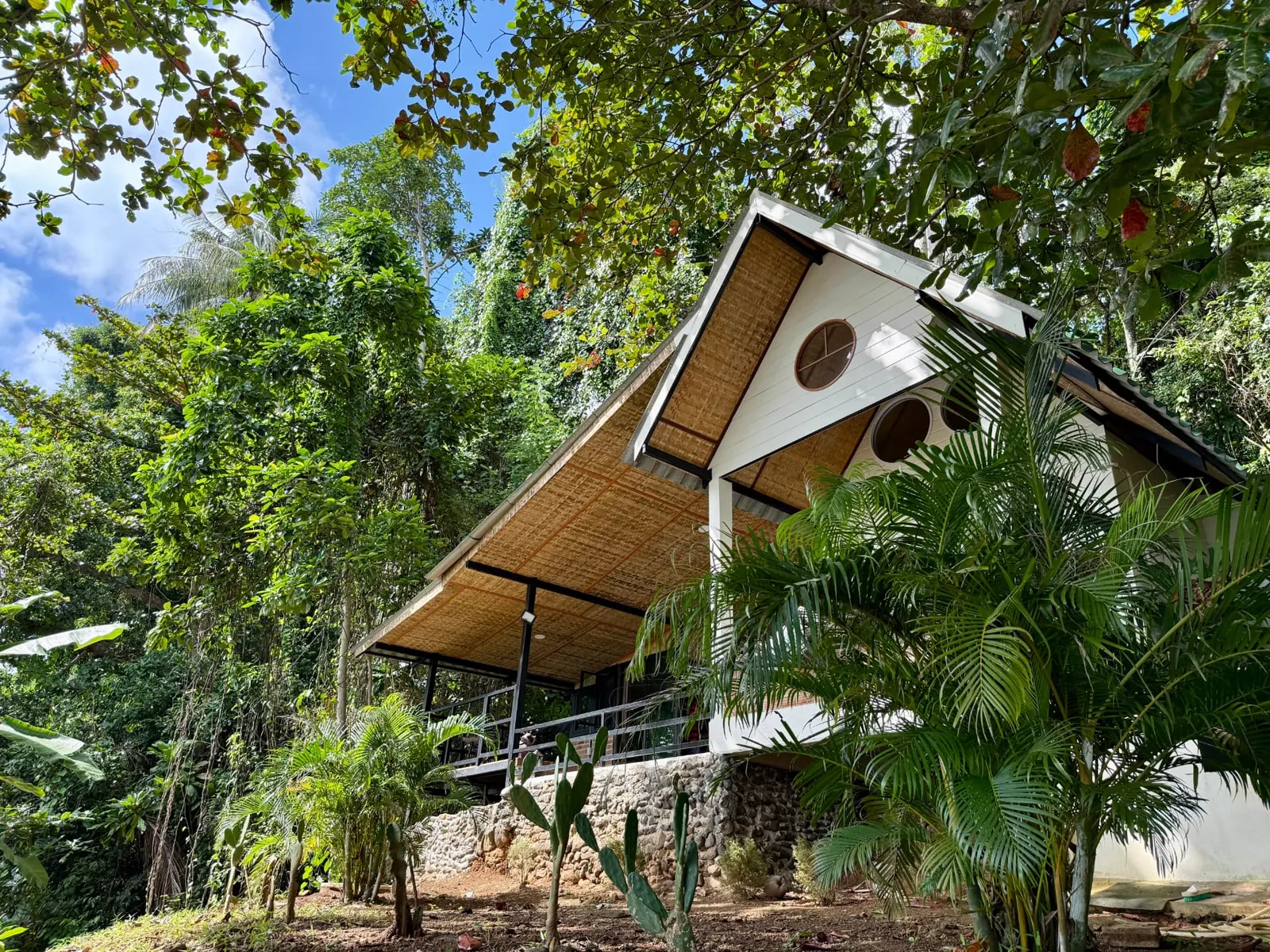 Little Bay House exterior with bamboo roof and tropical garden, Ao Nid, Koh Mak