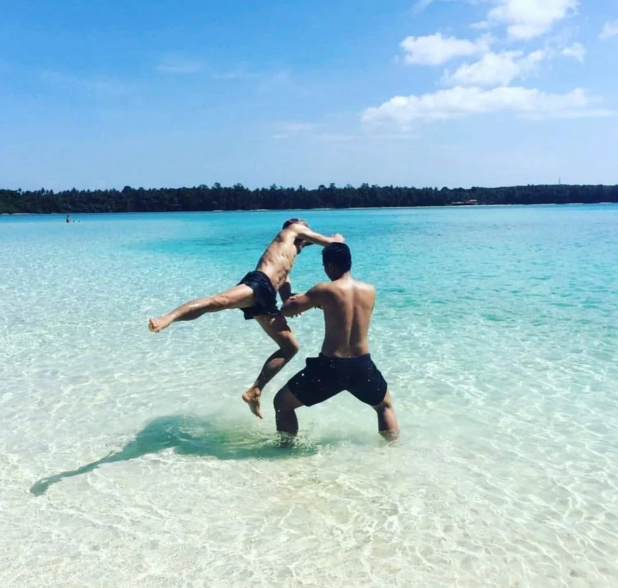 Muay Thai training in shallow turquoise water on a tropical beach on Koh Mak