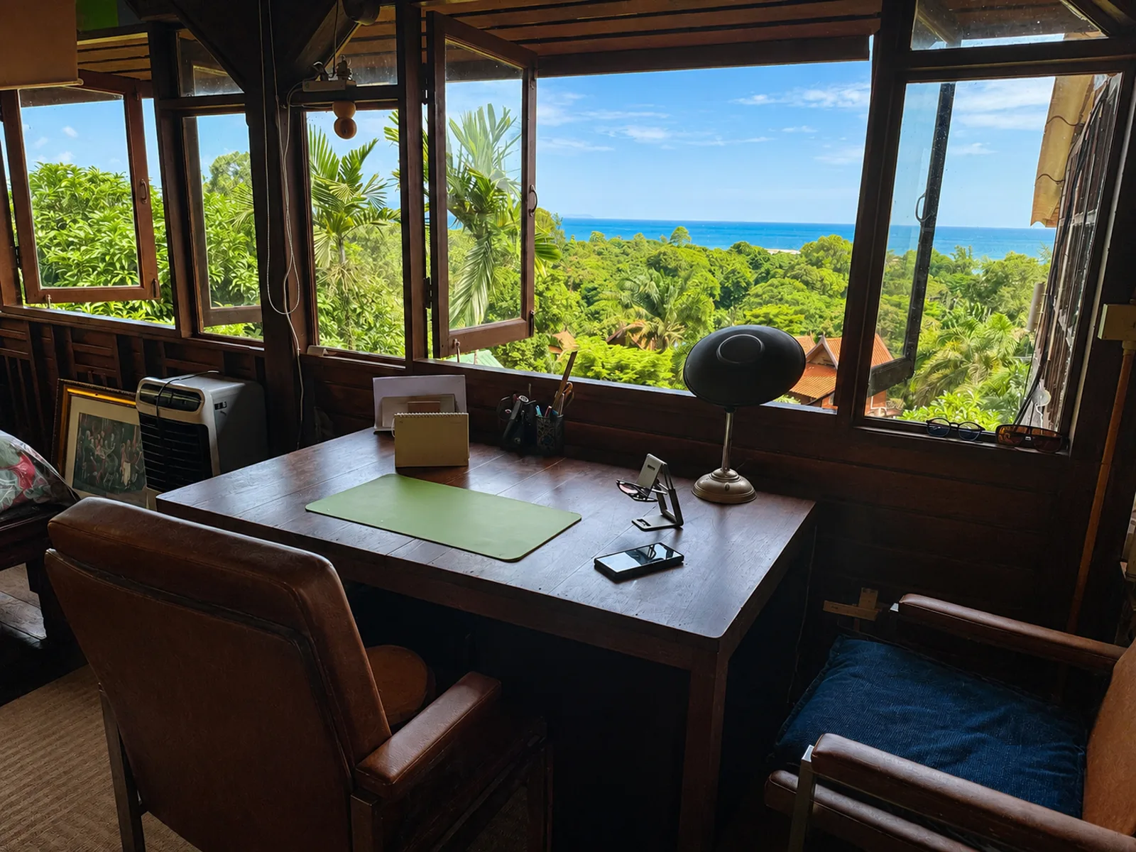 Wooden working desk by open windows with a tropical sea view at Seaview Suites Upstairs on Koh Mak