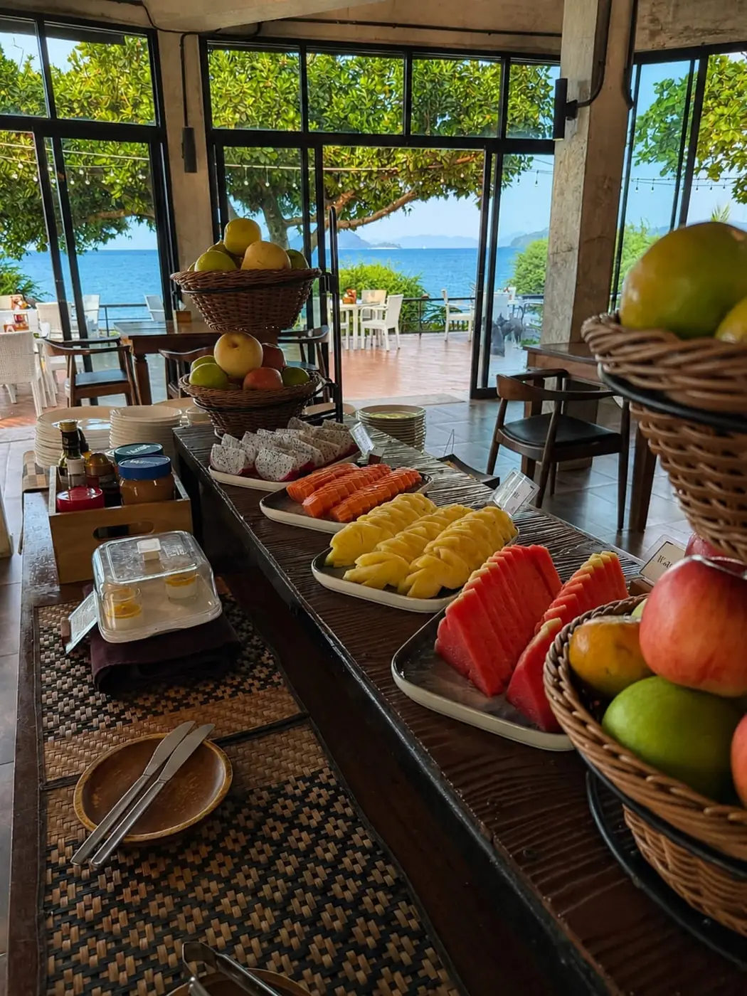 Fresh fruit breakfast buffet at White Sand Beach Restaurant with sea view through the windows