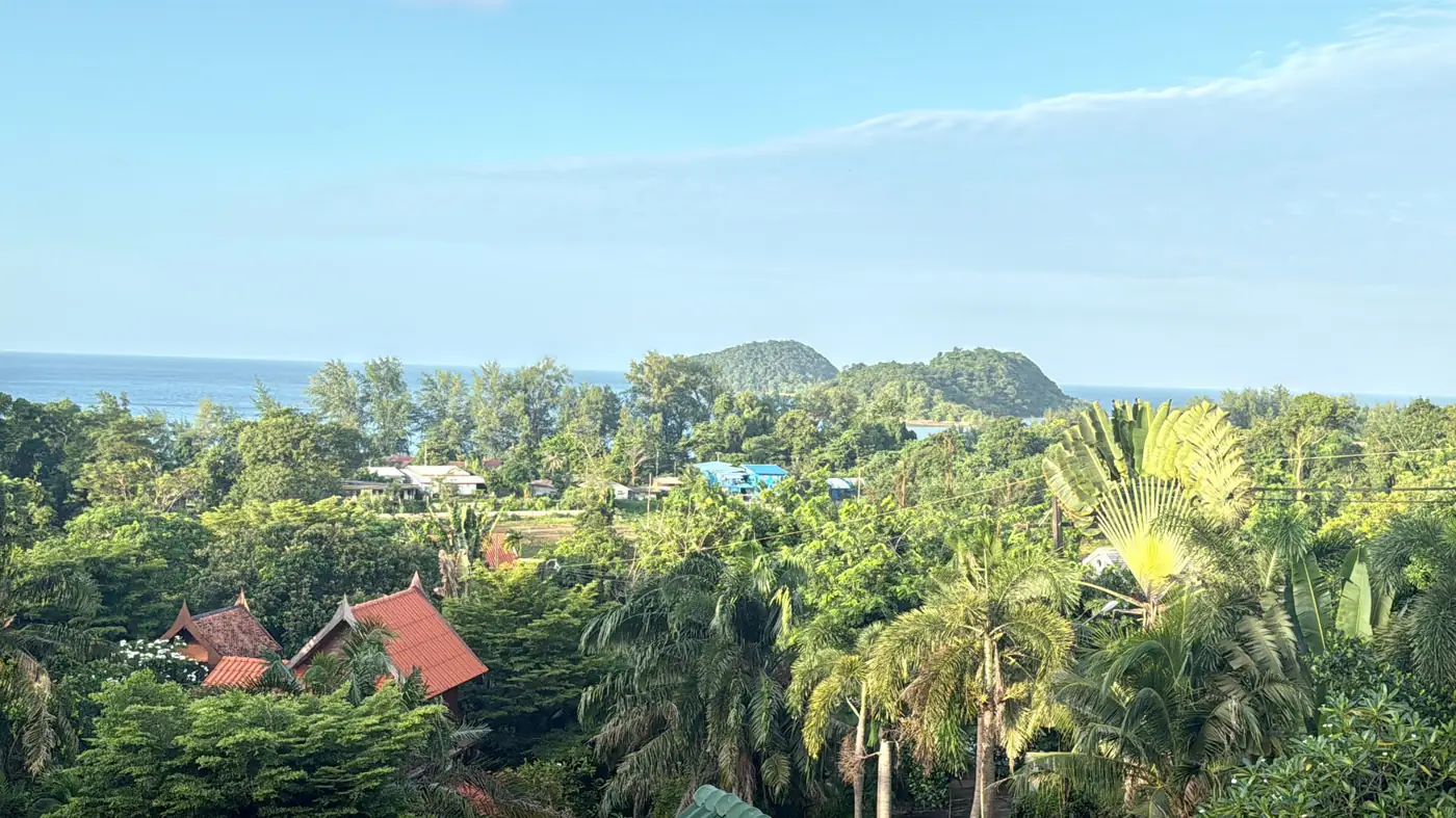 Panoramic view from the Upstairs seaview suite over tropical treetops towards the bay and islands near Koh Mak