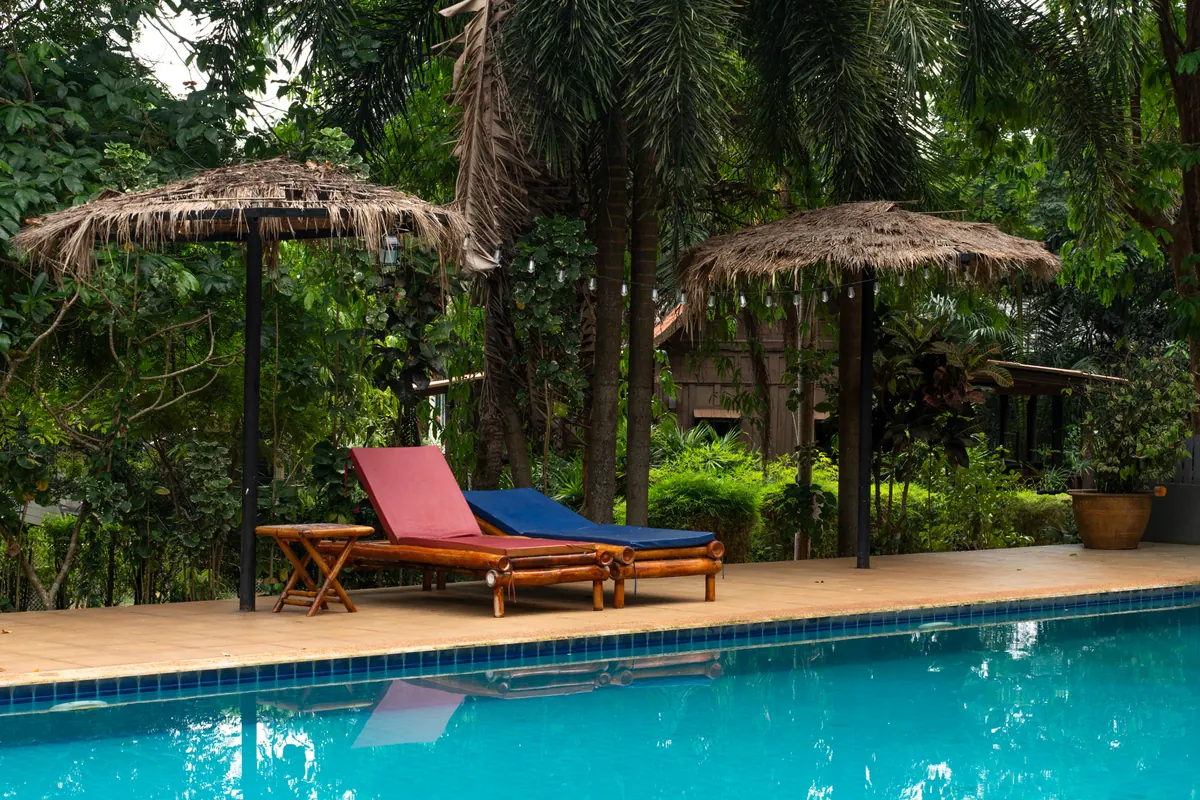Shared resort swimming pool with bamboo daybeds available to Pineapple Villa guests