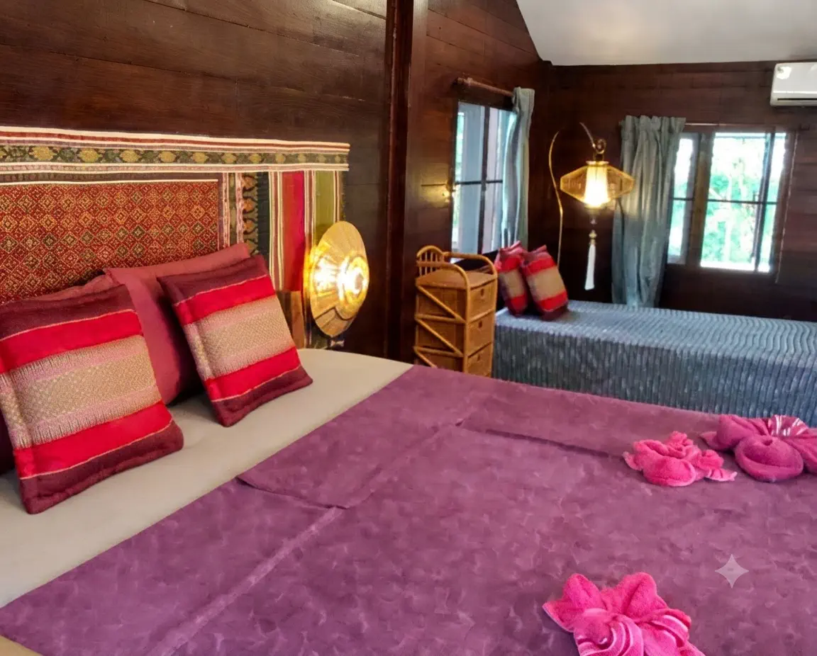 Top-floor bedroom with double and single beds, air conditioning and Thai textiles at Pineapple Villa on Koh Mak