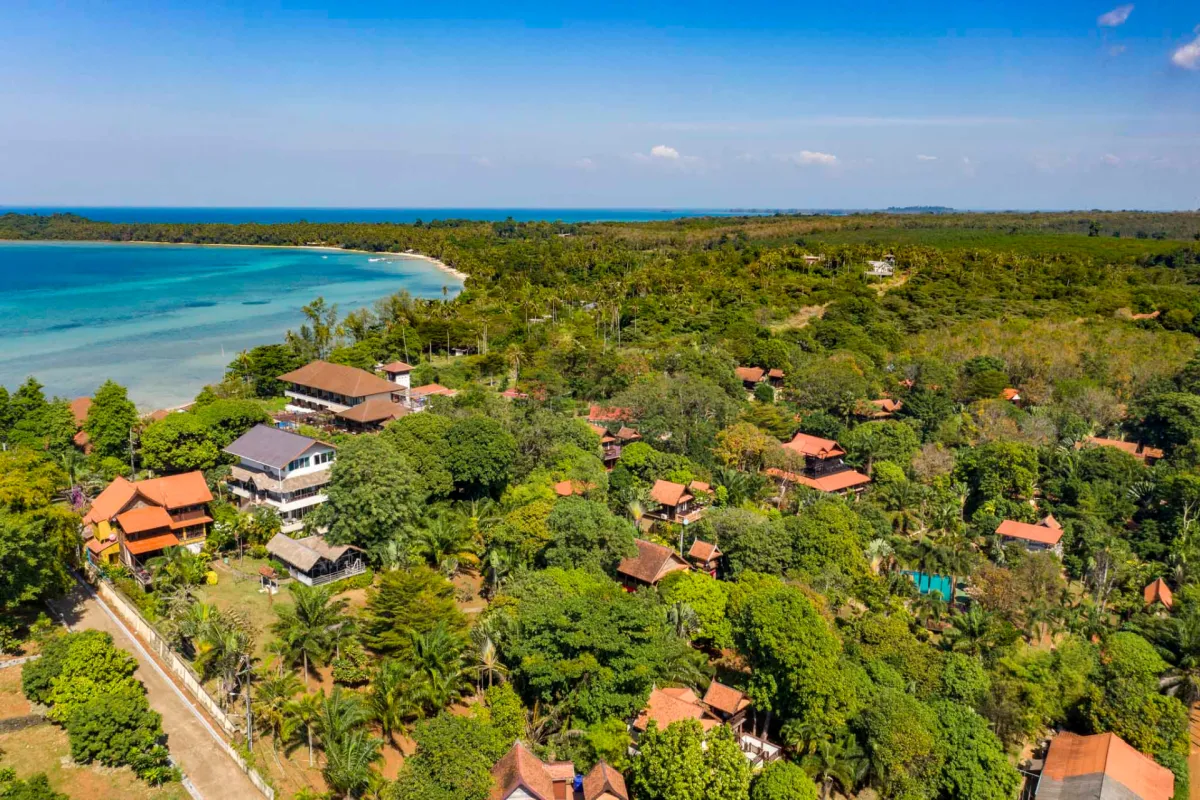 Aerial view of Koh Mak Village and Upstairs seaview suites with turquoise bay and tropical greenery