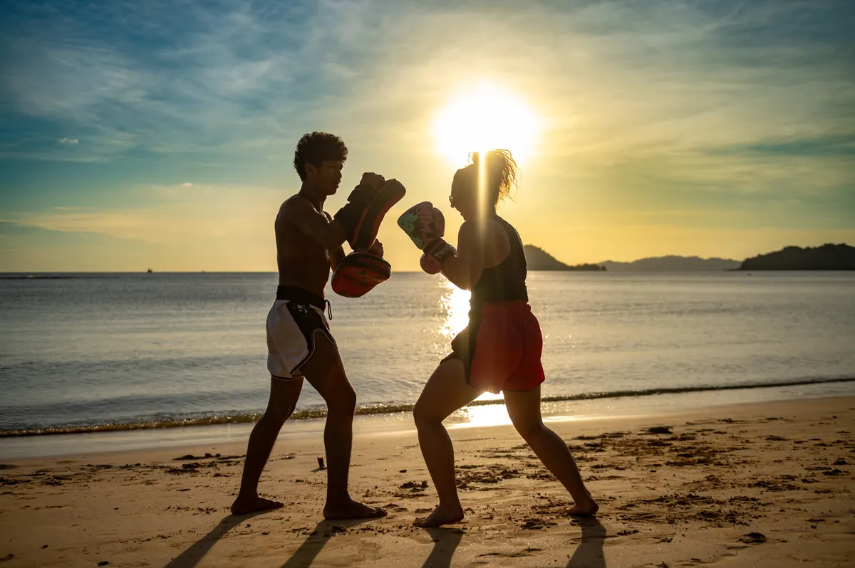 Muay Thai pad work on the beach at sunset on Koh Mak