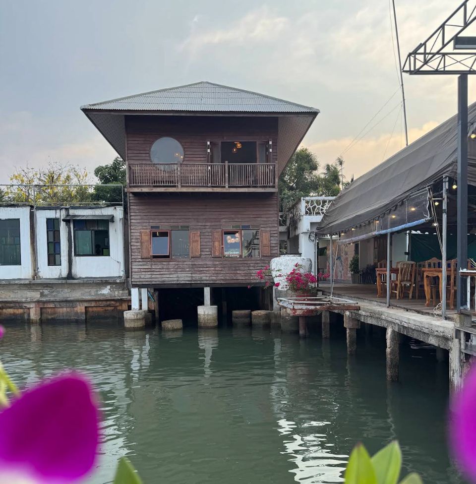 Koh Mak Seafood restaurant — wooden stilt house over the water at golden hour