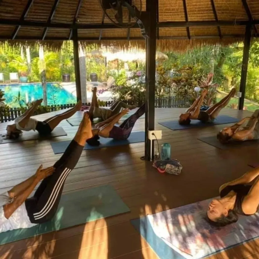 Yoga and Pilates class in an open-air pavilion by the pool on Koh Mak