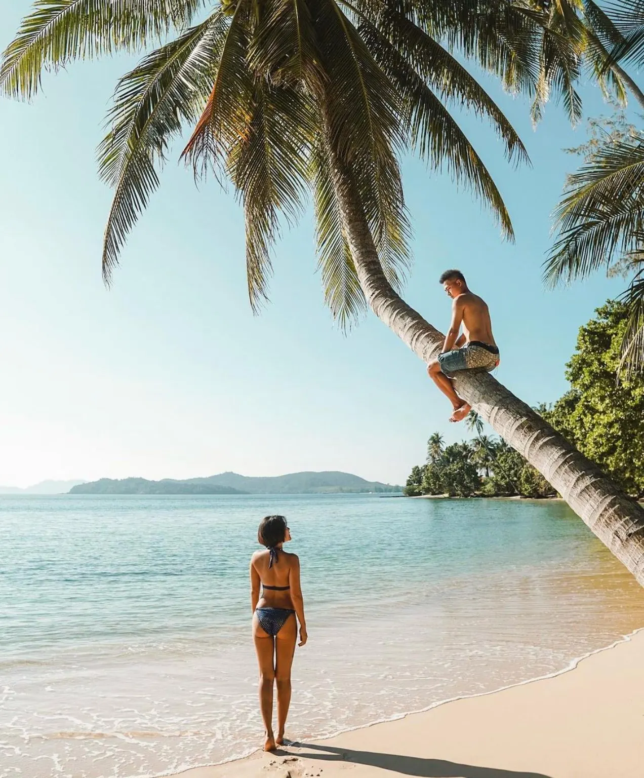 Couple at a palm-lined beach on Ao Kao, Koh Mak